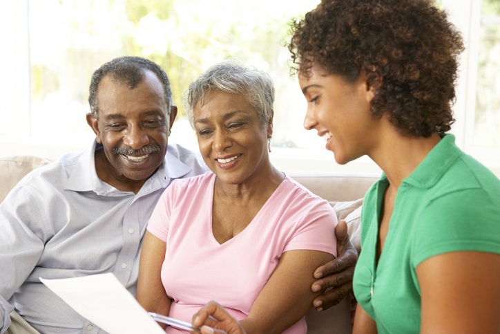 In Shreveport, LA, a woman and a senior couple sit to discuss nursing home services for The Guest House Skilled Nursing & Rehabilitation.